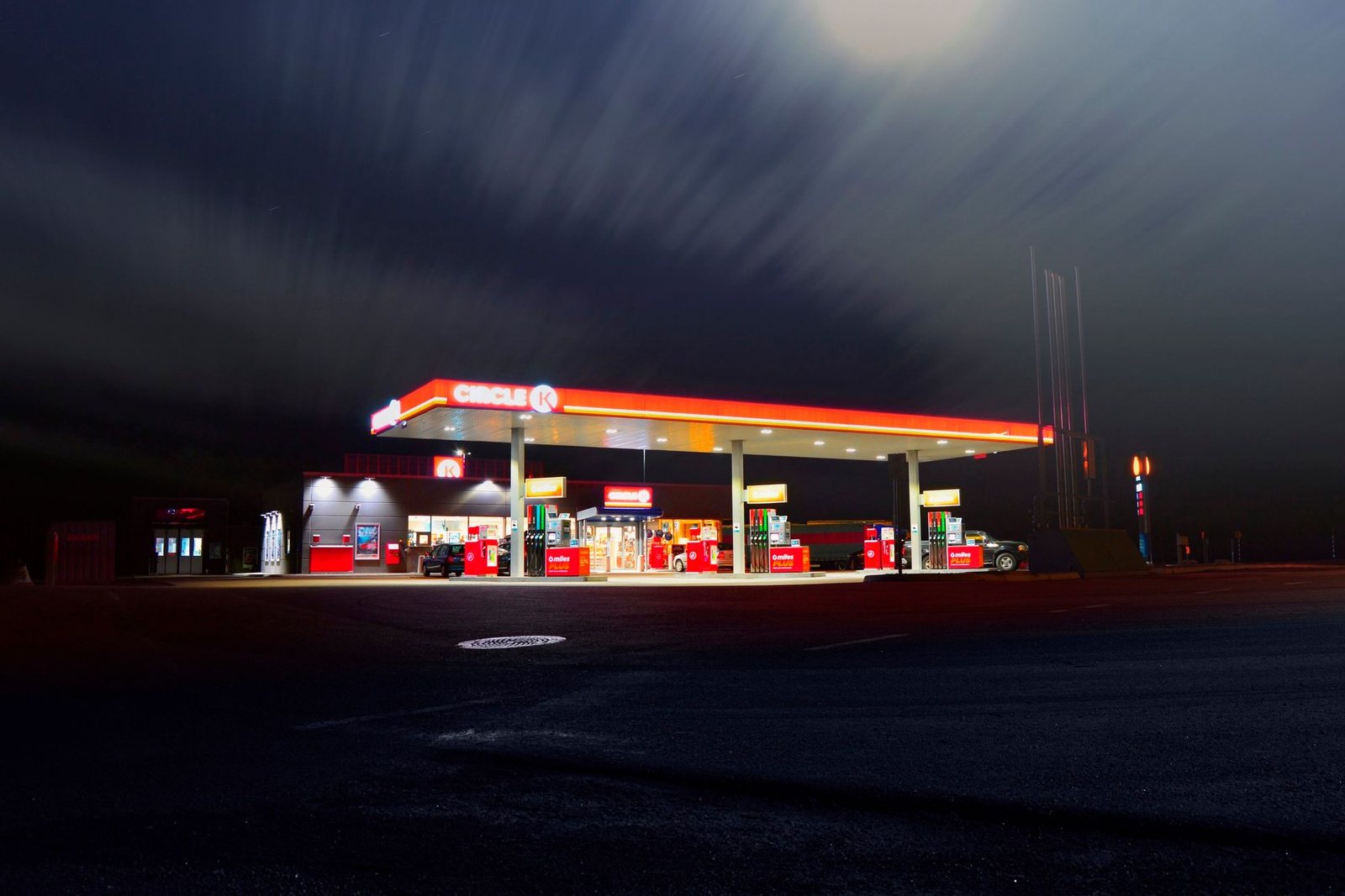 A gas station and convenience store lit at dusk.